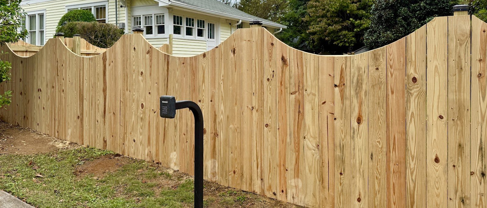 Arched wood privacy fence line built by Siler Fence Company