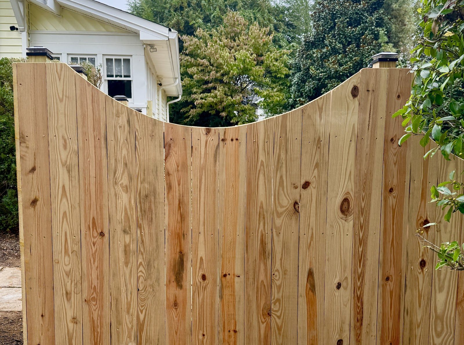 Arched-top wood privacy fence built by Siler Fence Company